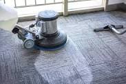 A floor cleaning machine is on the ground.